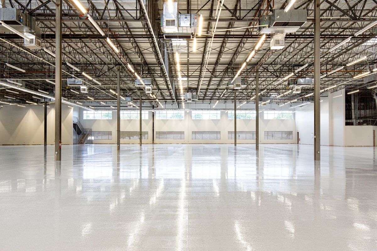Spacious commercial warehouse with a light-reflective, glossy coated concrete floor